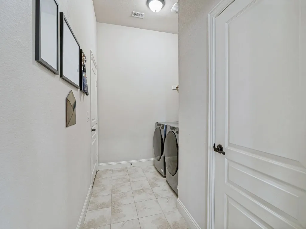 Laundry room featuring baseboards and washing machine and clothes dryer
