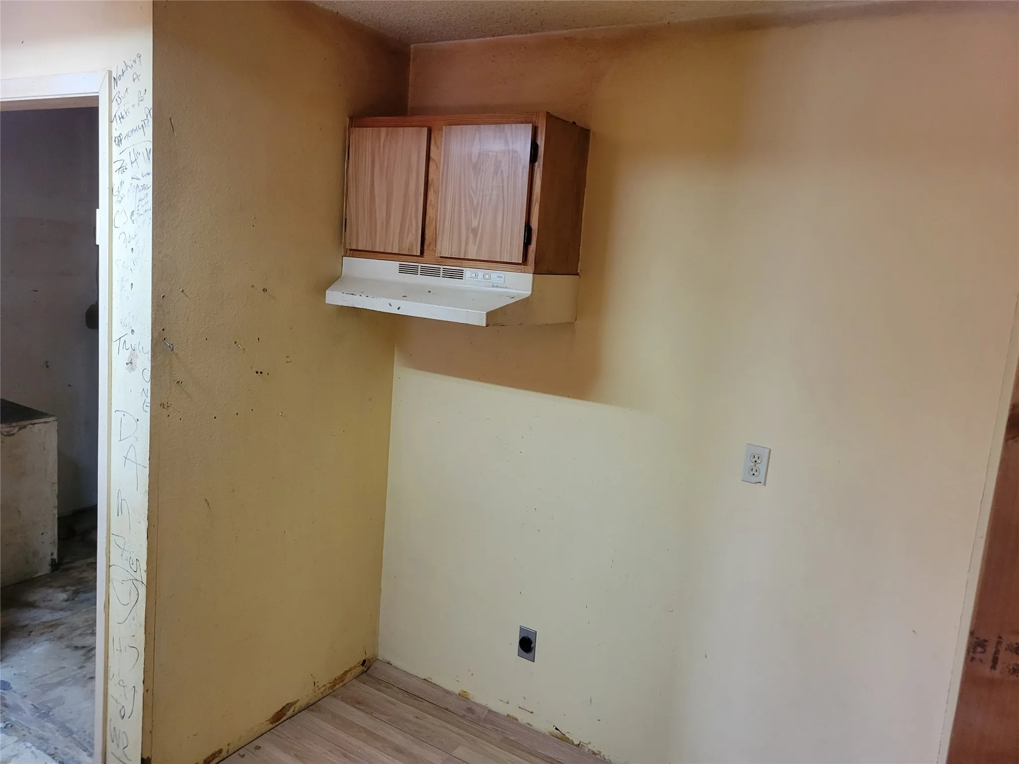 Laundry area featuring light wood finished floors and hookup for an electric dryer