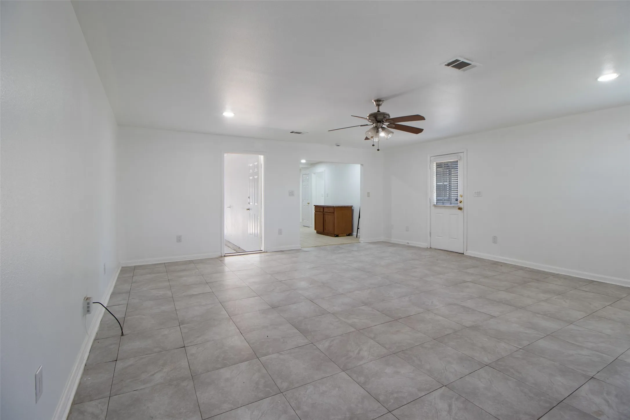 Living room with a ceiling fan and recessed lighting