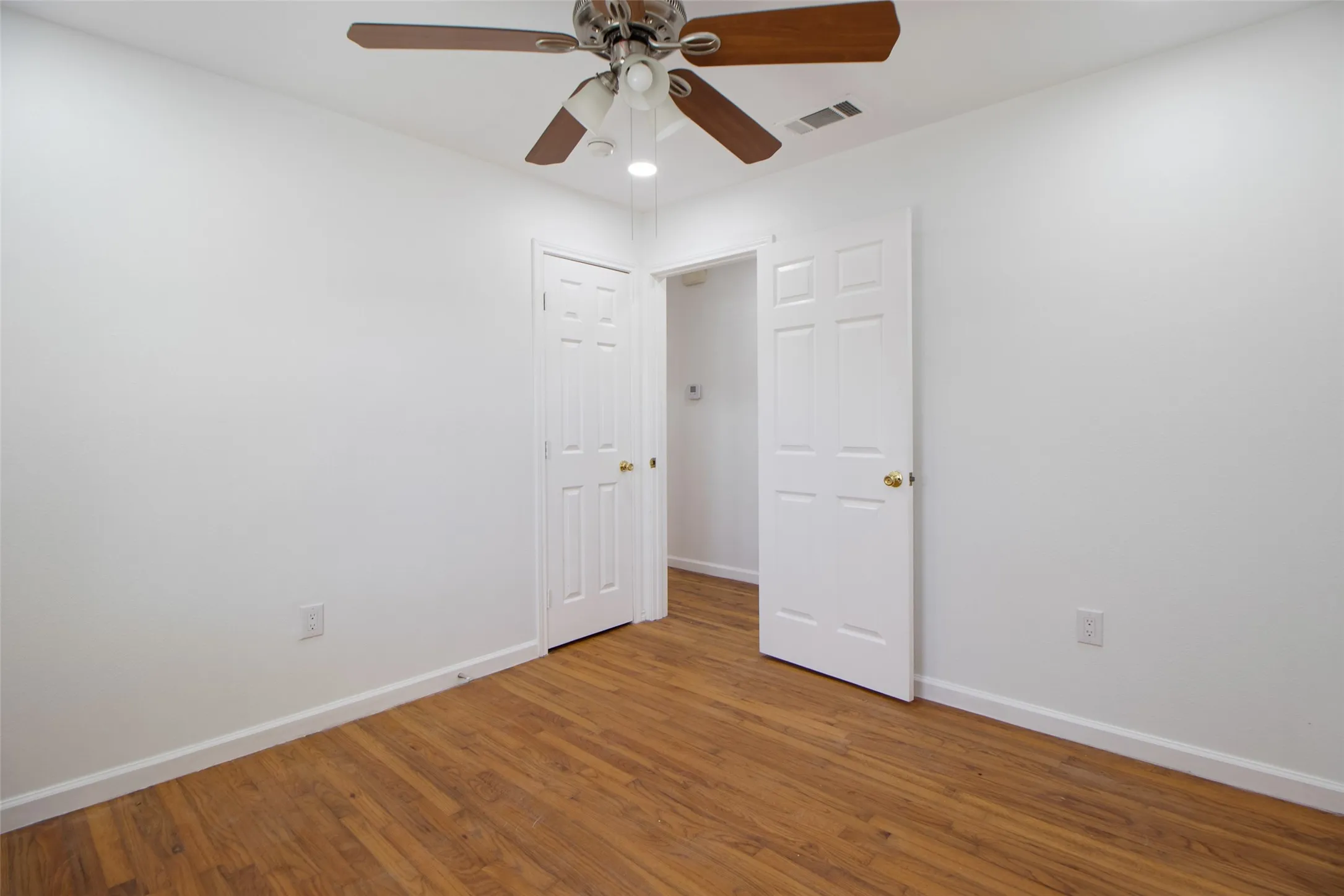 Spare room with ceiling fan and wood finished floors