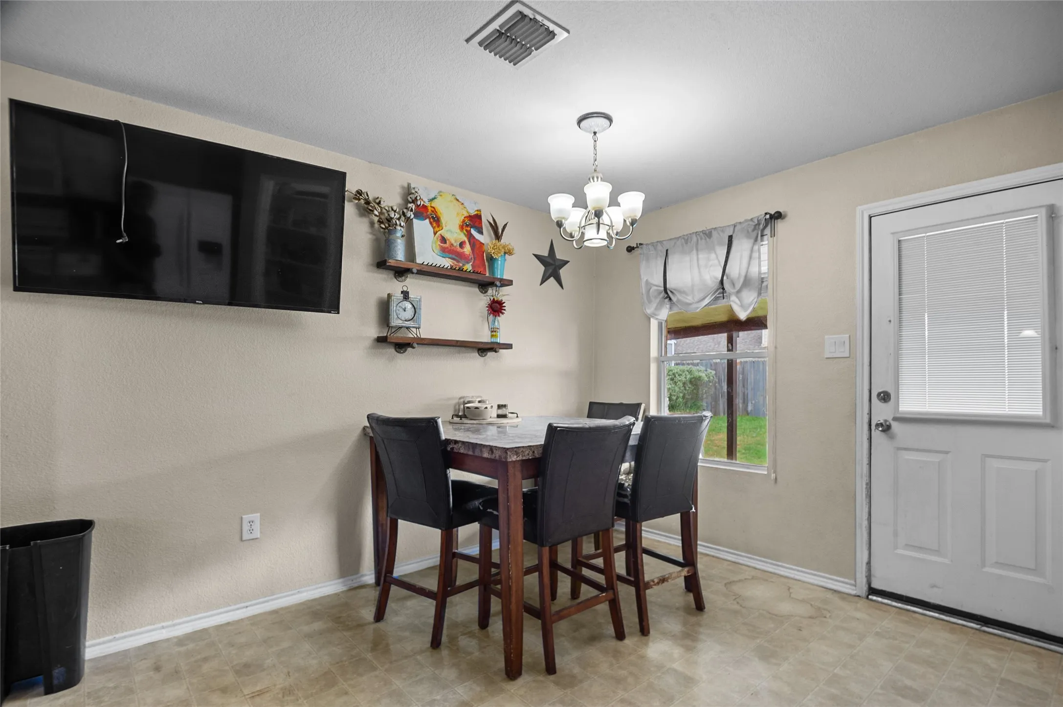 Dining room with a chandelier and baseboards