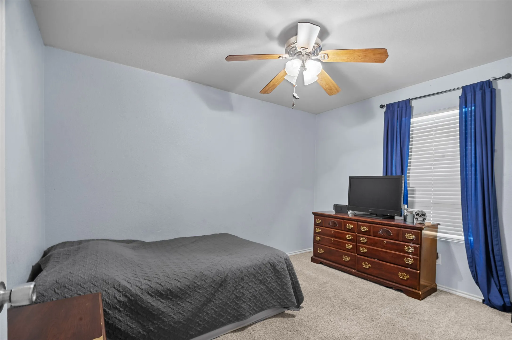 Carpeted bedroom with baseboards and ceiling fan
