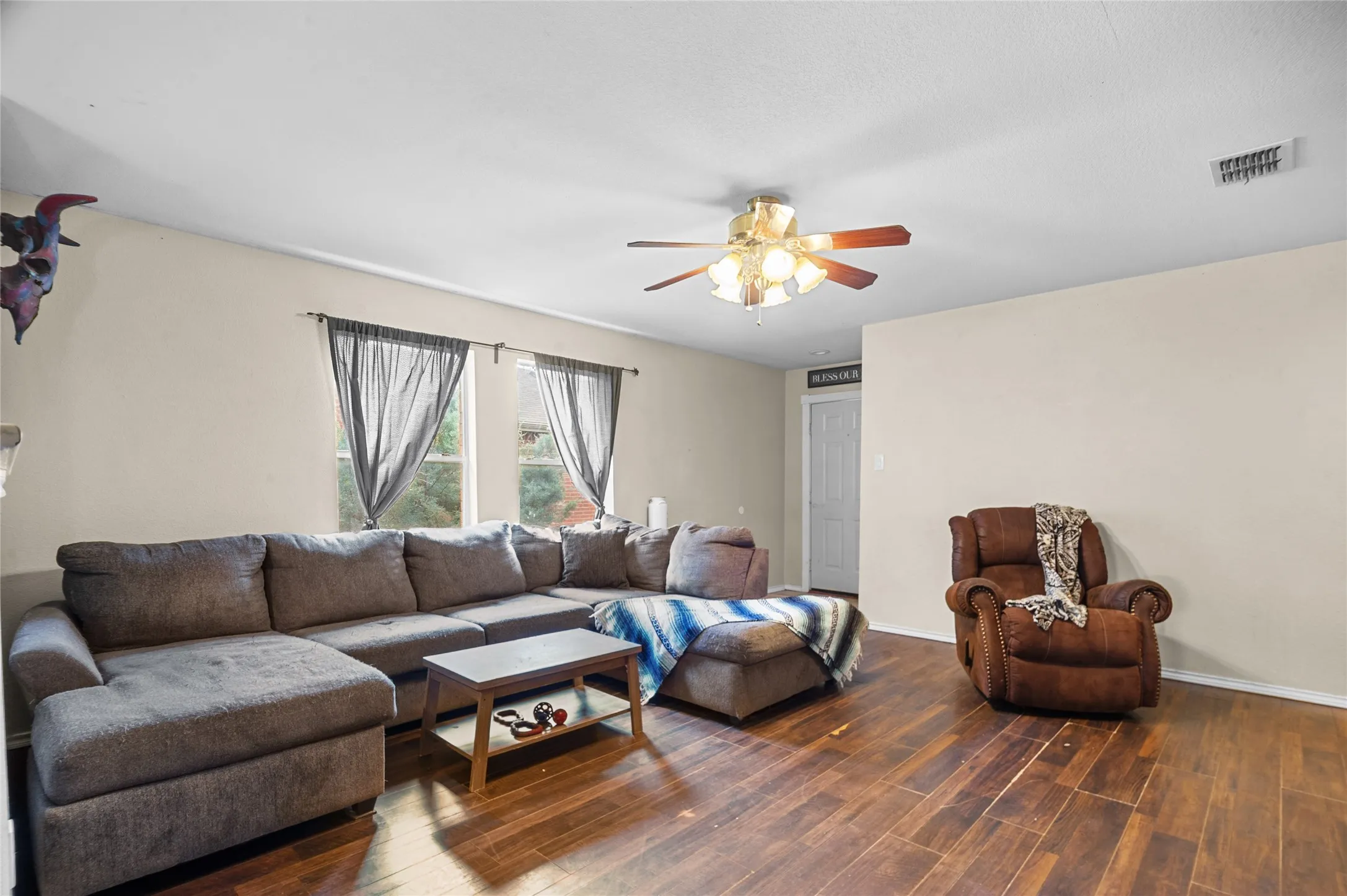 Living area featuring ceiling fan and wood finished floors