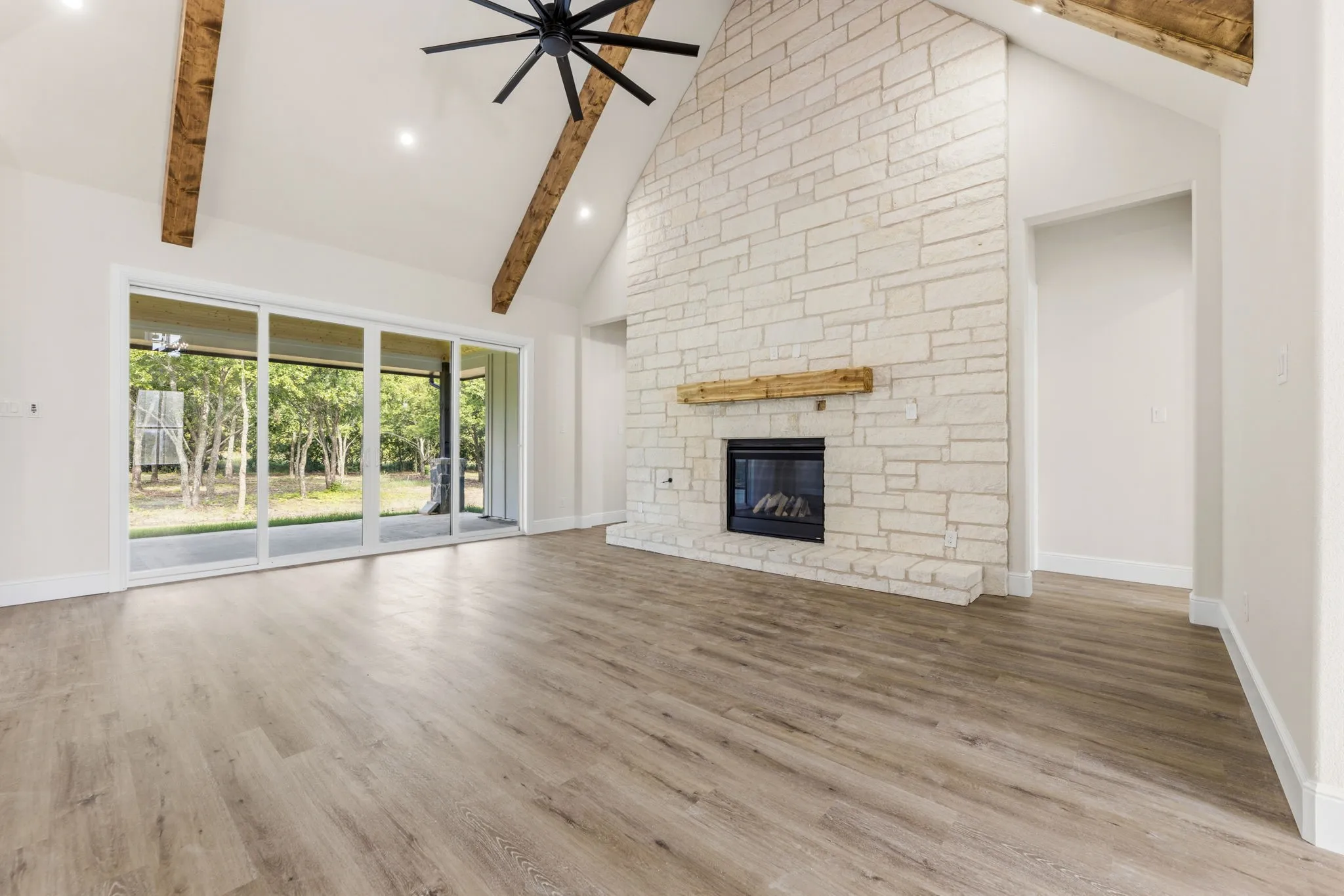 Gas log fireplace with floor to ceiling stone