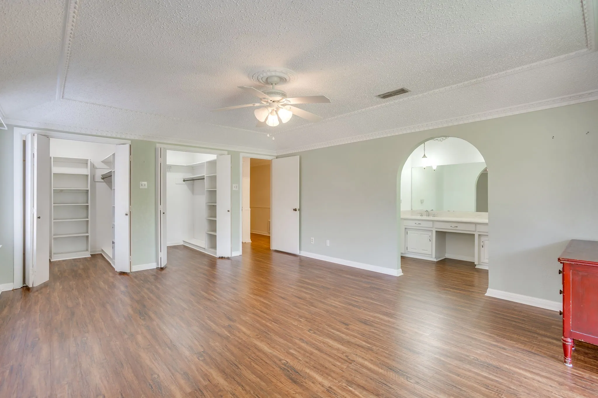 Two very large walk-in closets in the primary bedroom. View shows the counter in the primary bathroom.