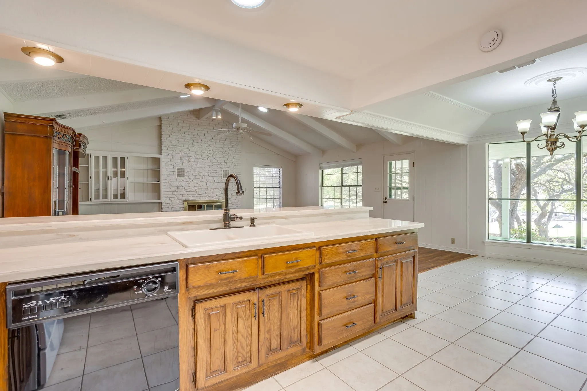 This view shows the open floorplan of the kitchen and living room. Windows across the back of the home which backs up to the fairway and the 18th hole. Steps away from the clubhouse.