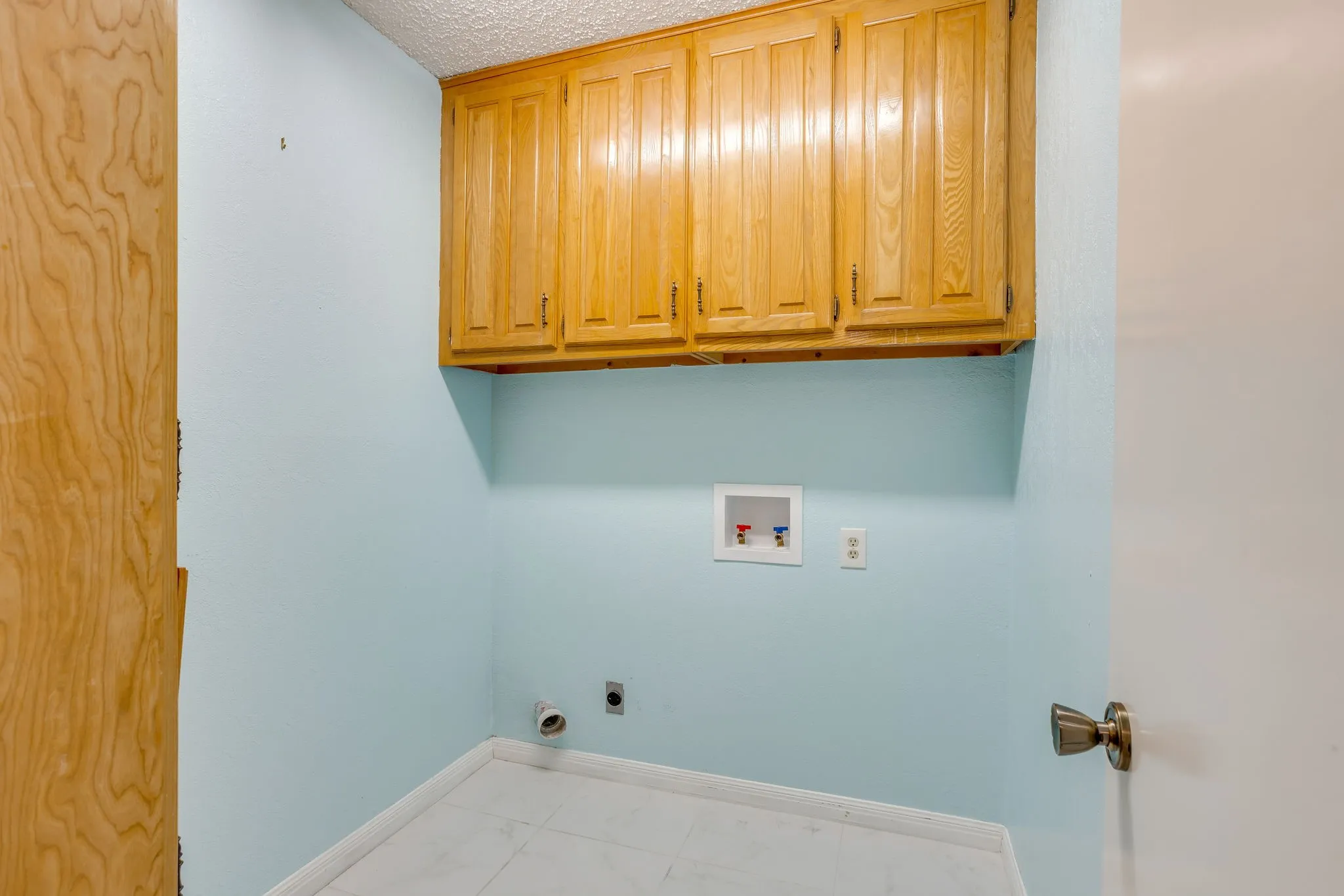 Separate Utility Room with built in overhead and linen cabinets.