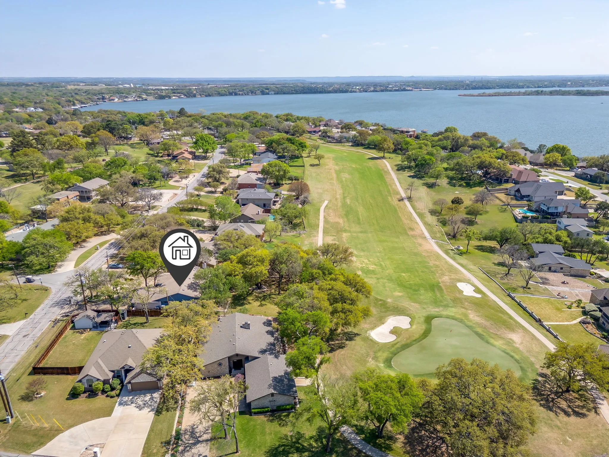Property backs up to the 18th hole. Several trees in backyard provides shade. View of the lake is possible from this yard also.