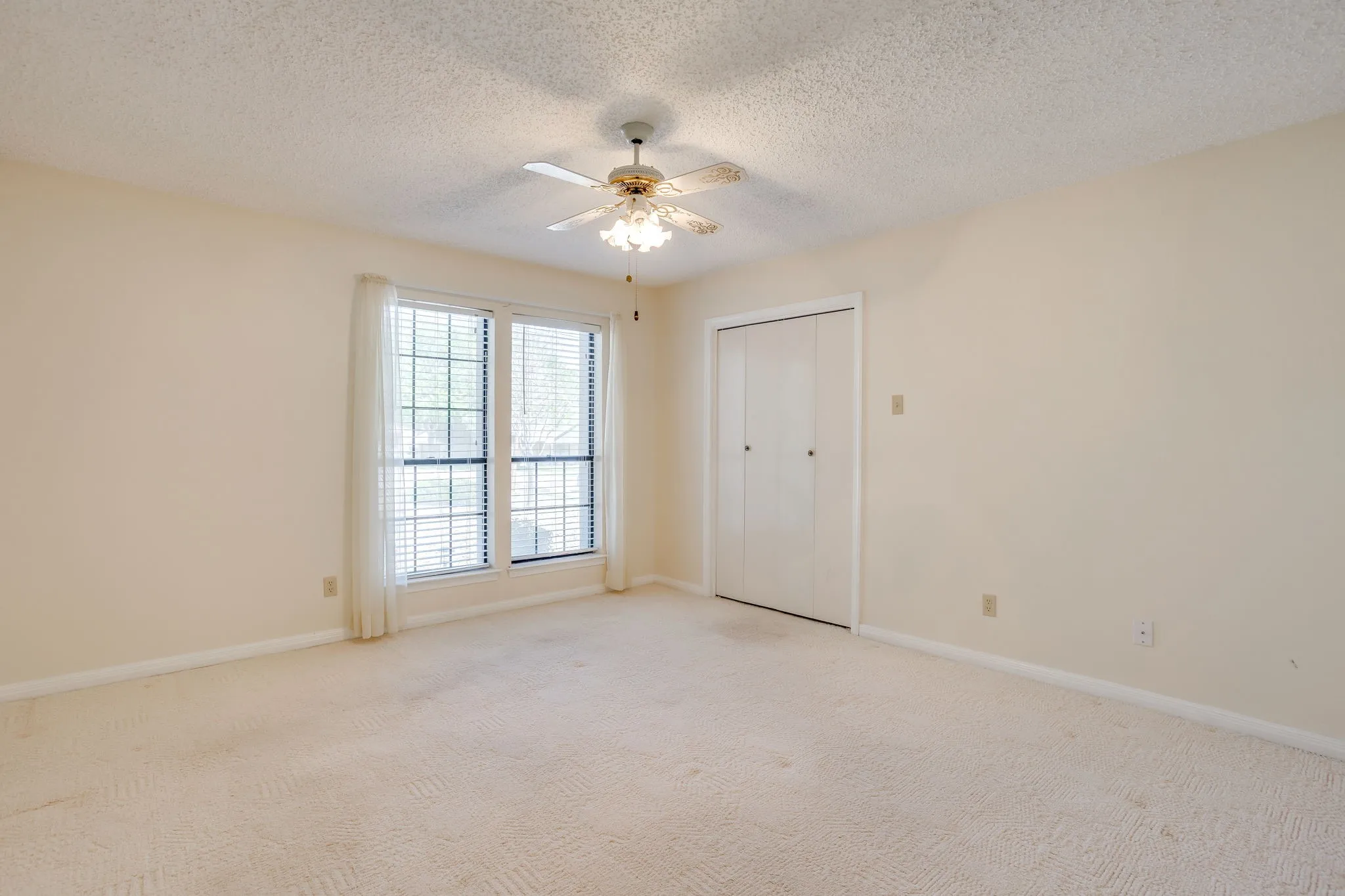 This bedroom is on the same hallway as the other bedroom which is separate from the Primary Bedroom. The closet has built in shelves.