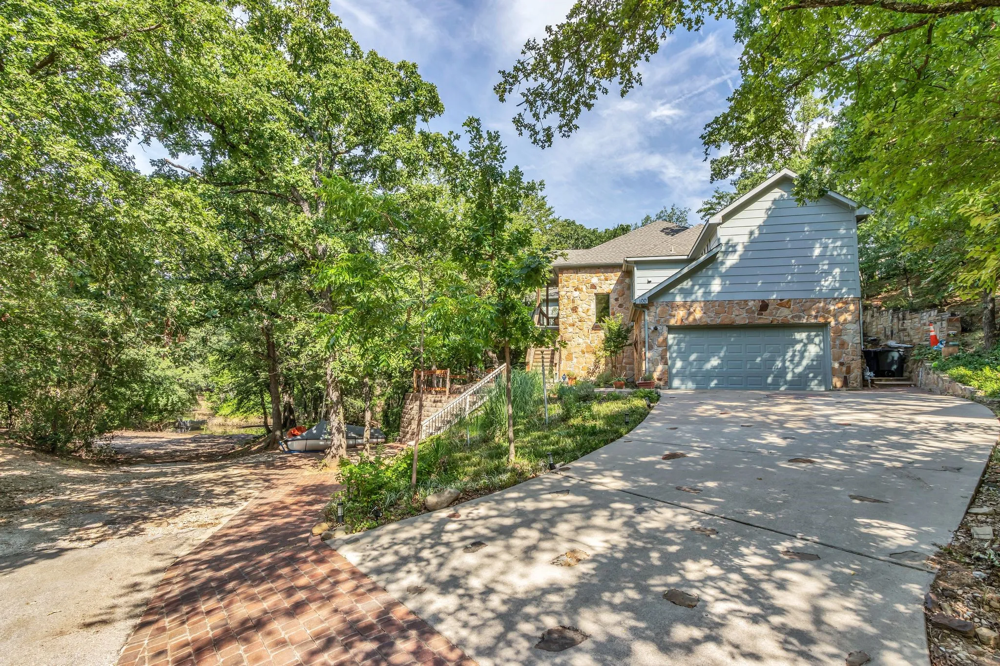 Stone and siding exterior with an attached garage