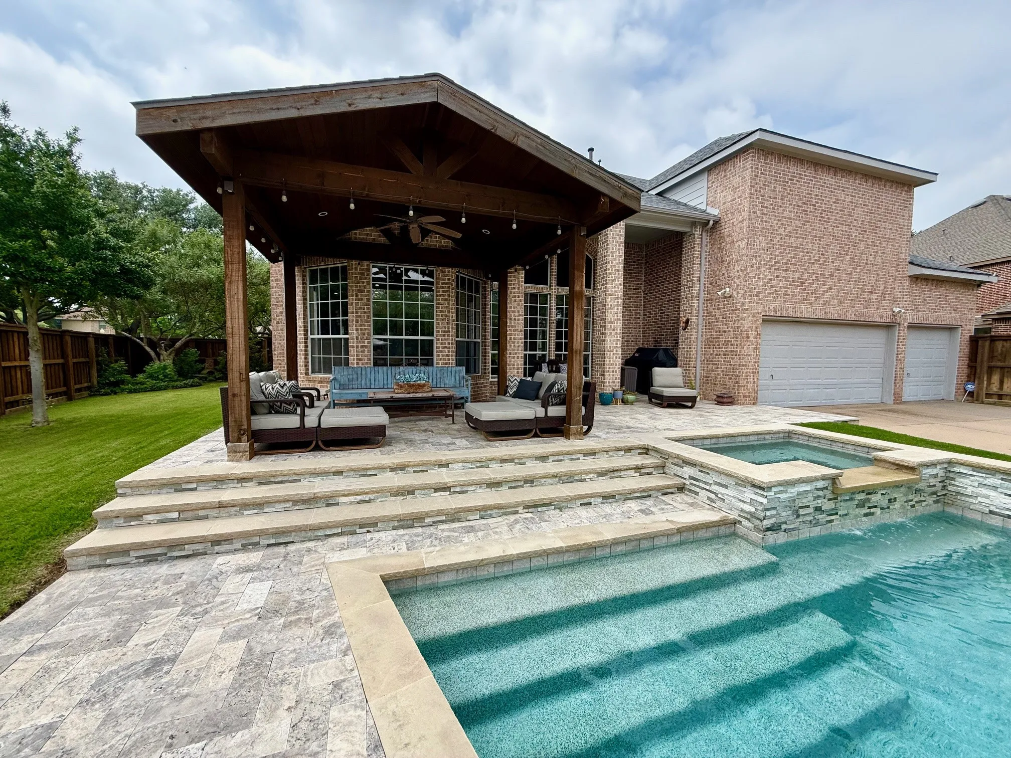 Step outside to your private backyard oasis, an entertainers dream, featuring a sparkling pool with color changing lighting, tranquil waterfalls, a Badu Swim Jet System, and a relaxing spa.