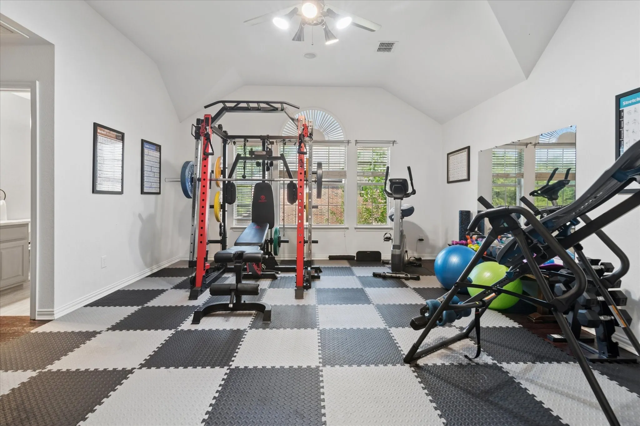 A spacious bonus room is currently designed as a fully equipped home gym, offering a rare opportunity for a turnkey fitness space, or easily transition into a playroom or additional living area.