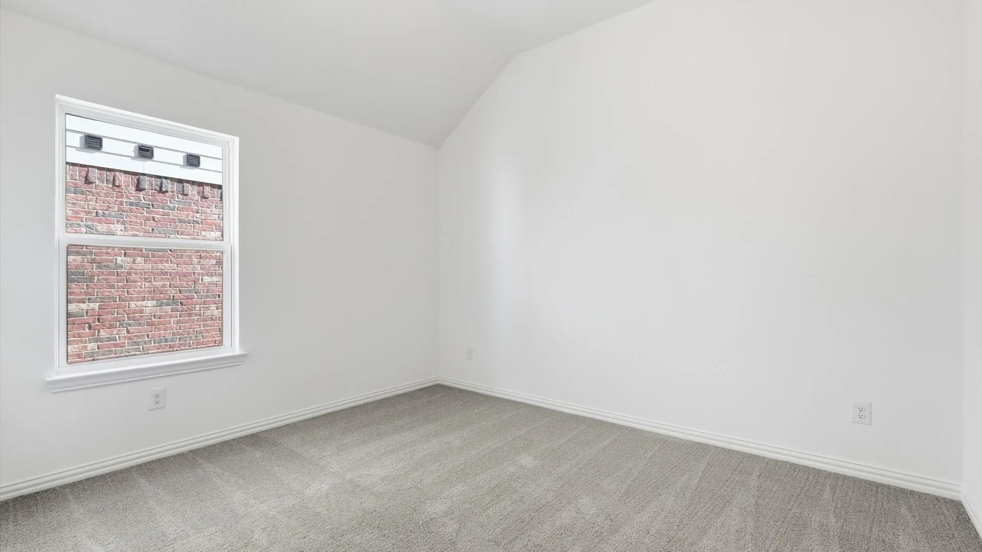 Room featuring neutral gray carpeting and white baseboards