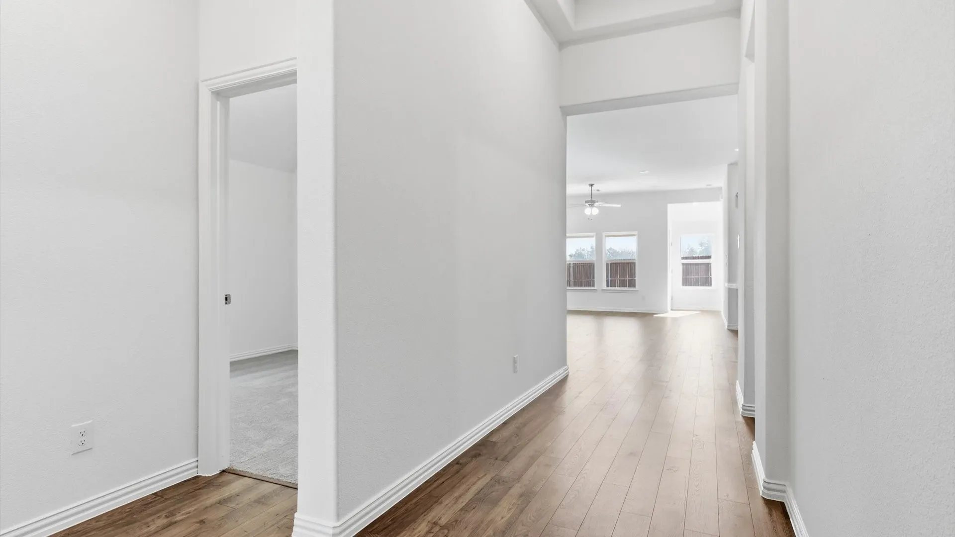 Entryway featuring wood-finish flooring, white baseboards, and neutral wall tones