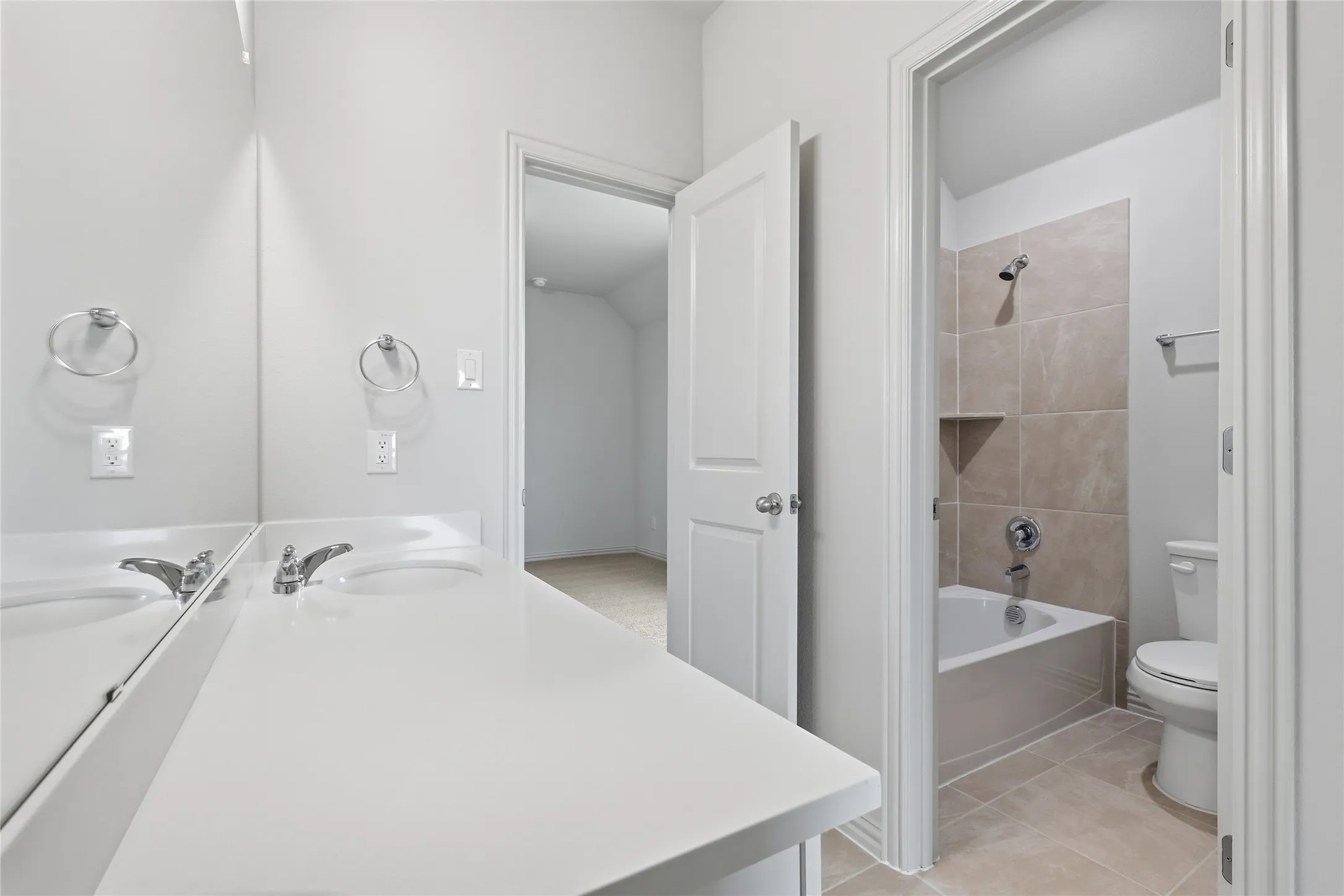 Double vanity with integrated sinks and white countertops