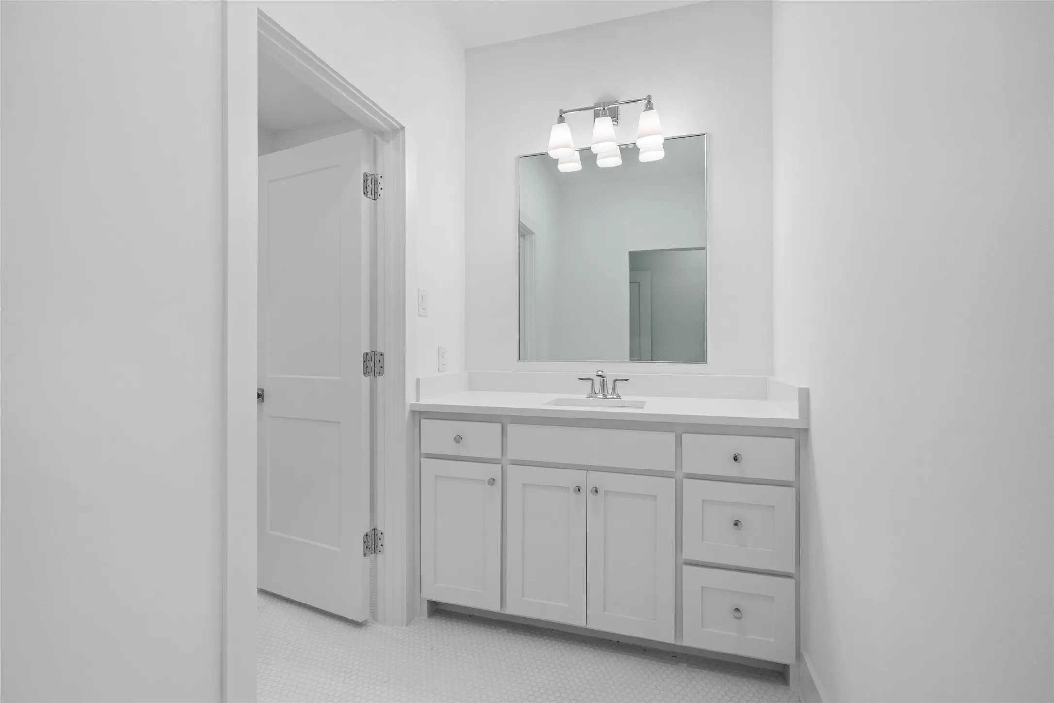 The Jack and Jill bathroom between two second floor bedrooms features a vanity with sink for each bedroom.