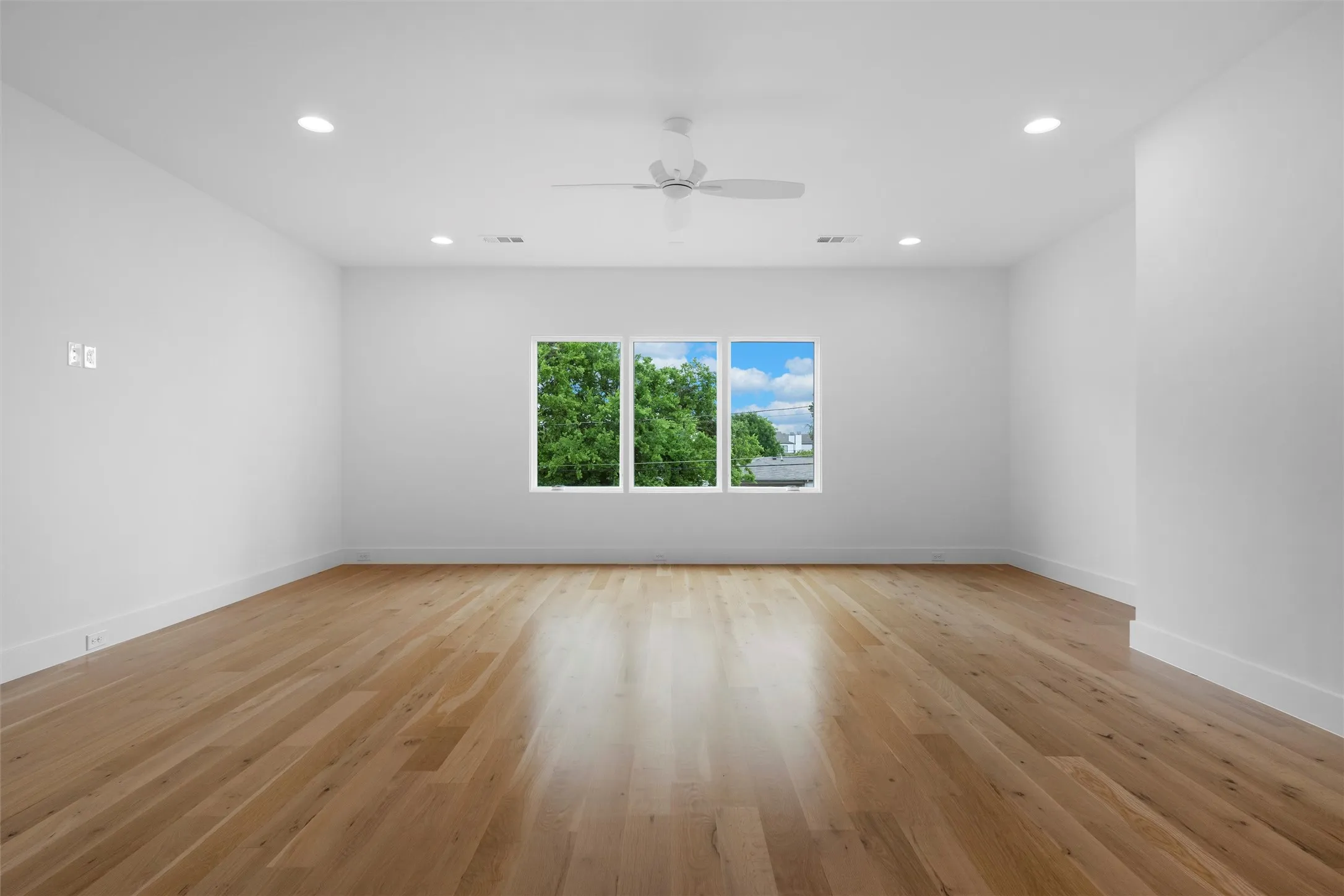 Extra large game room can also serve as media room!  Features include ceiling fan and light hardwood / wood-style floors and large windows overlooking the pool area.