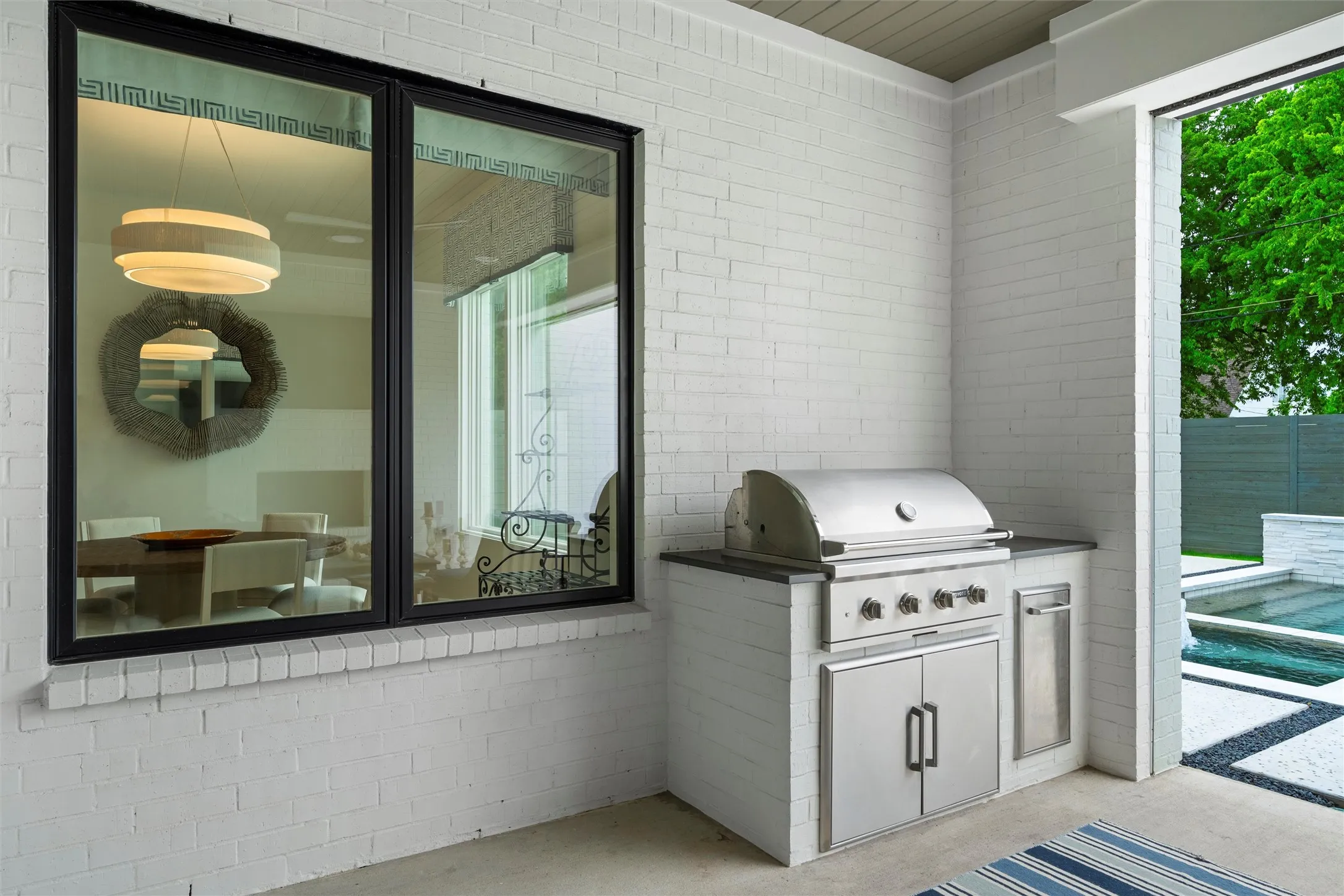 Patio with built in natural gas grill and trash cabinet.