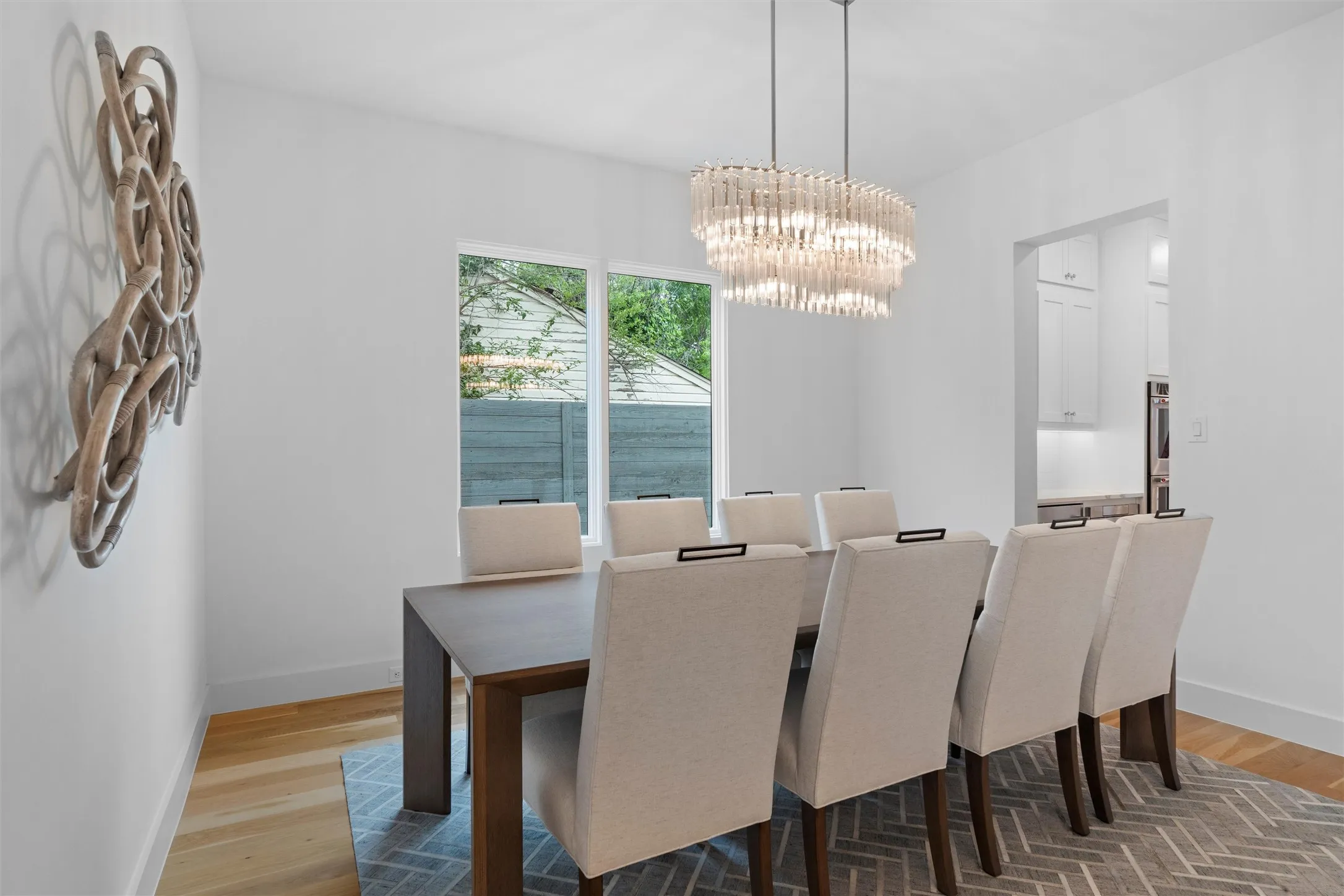 Dining room with a notable chandelier and hardwood / wood-style flooring.