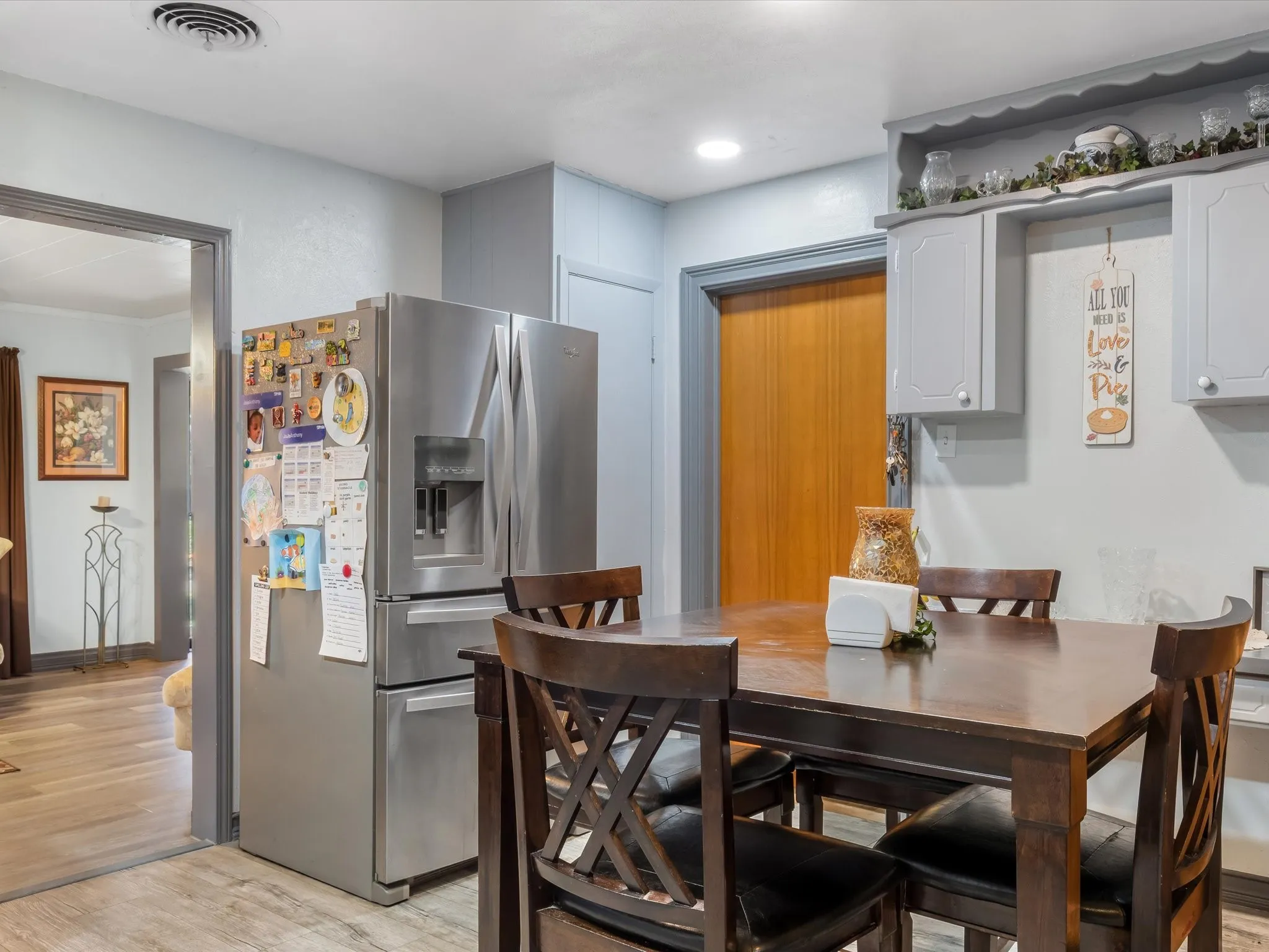 Kitchen with stainless steel appliances, light wood-style flooring, and gray cabinets