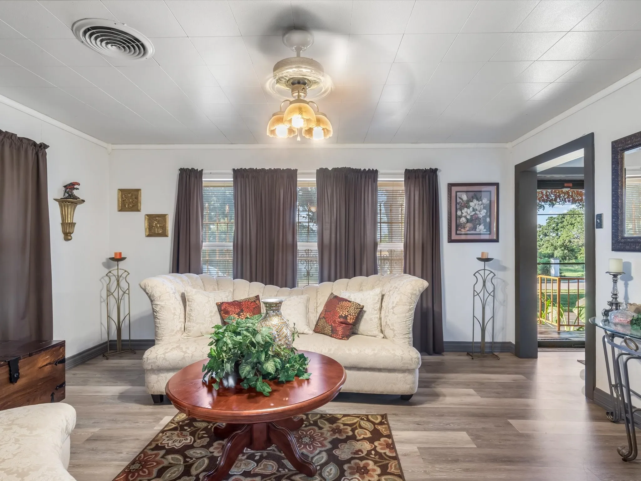 Living room featuring wood finished floors and ornamental molding