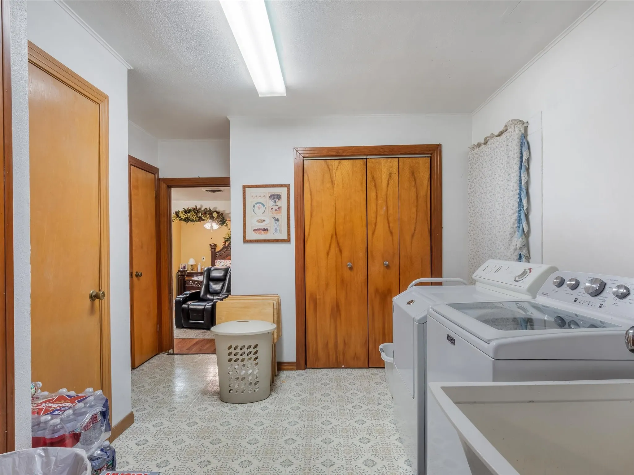 Laundry area featuring separate washer and dryer and light floors