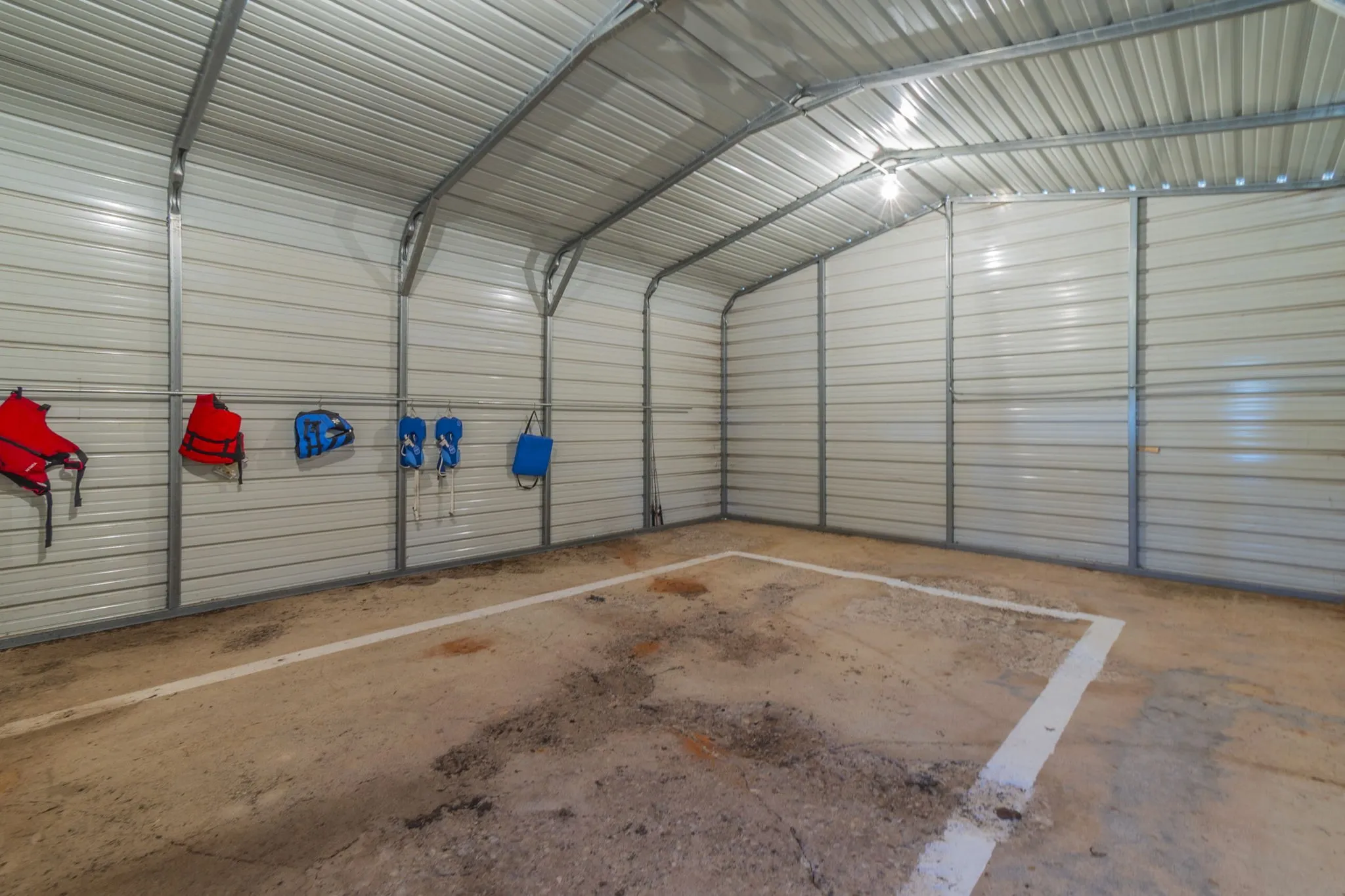 This spacious barn on concrete slab will fit a 21-foot boar and has an overhead door for ease of parking.