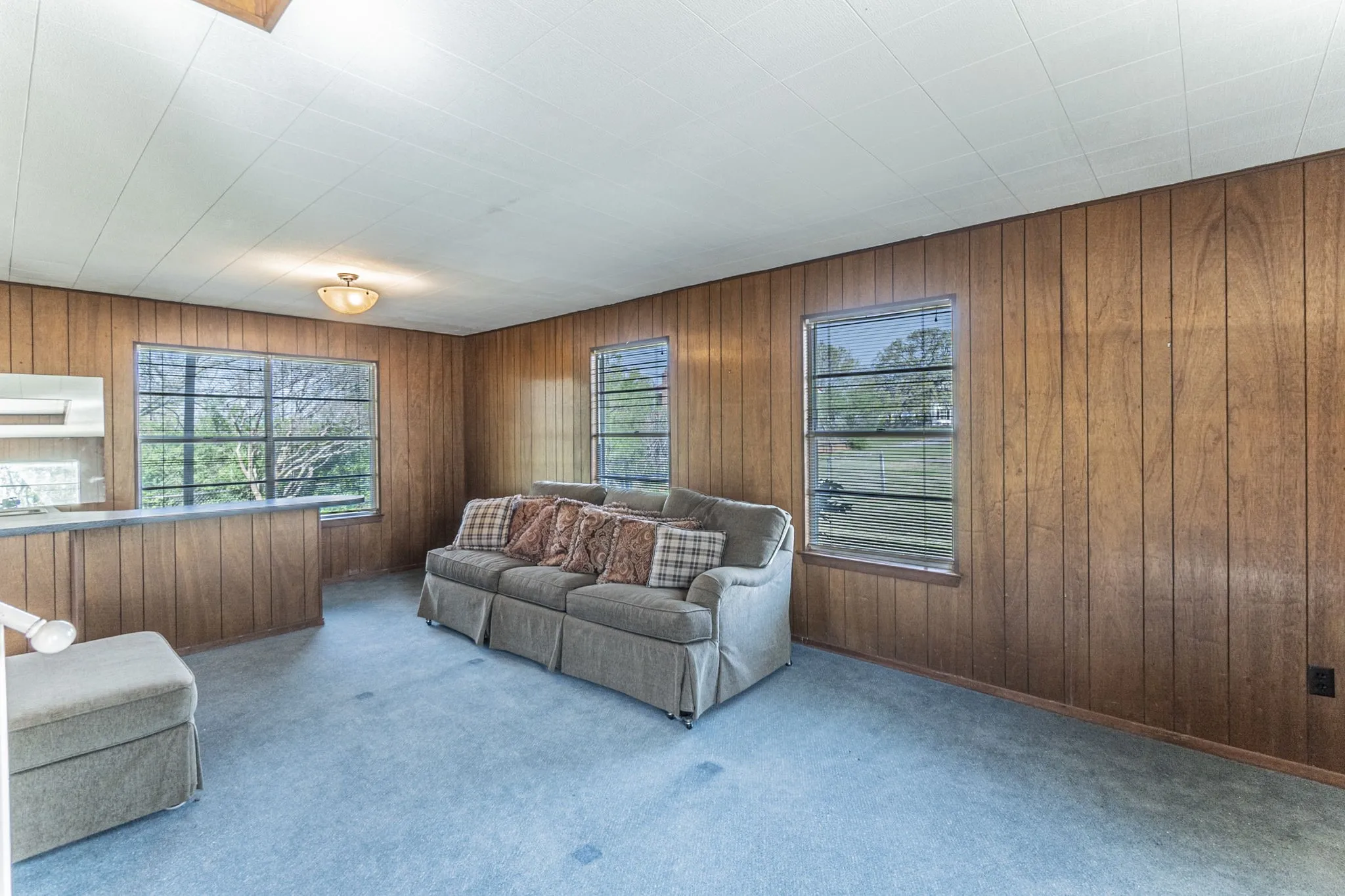 Spacious living room downstairs with wet bar at left. Furniture is negotiable.