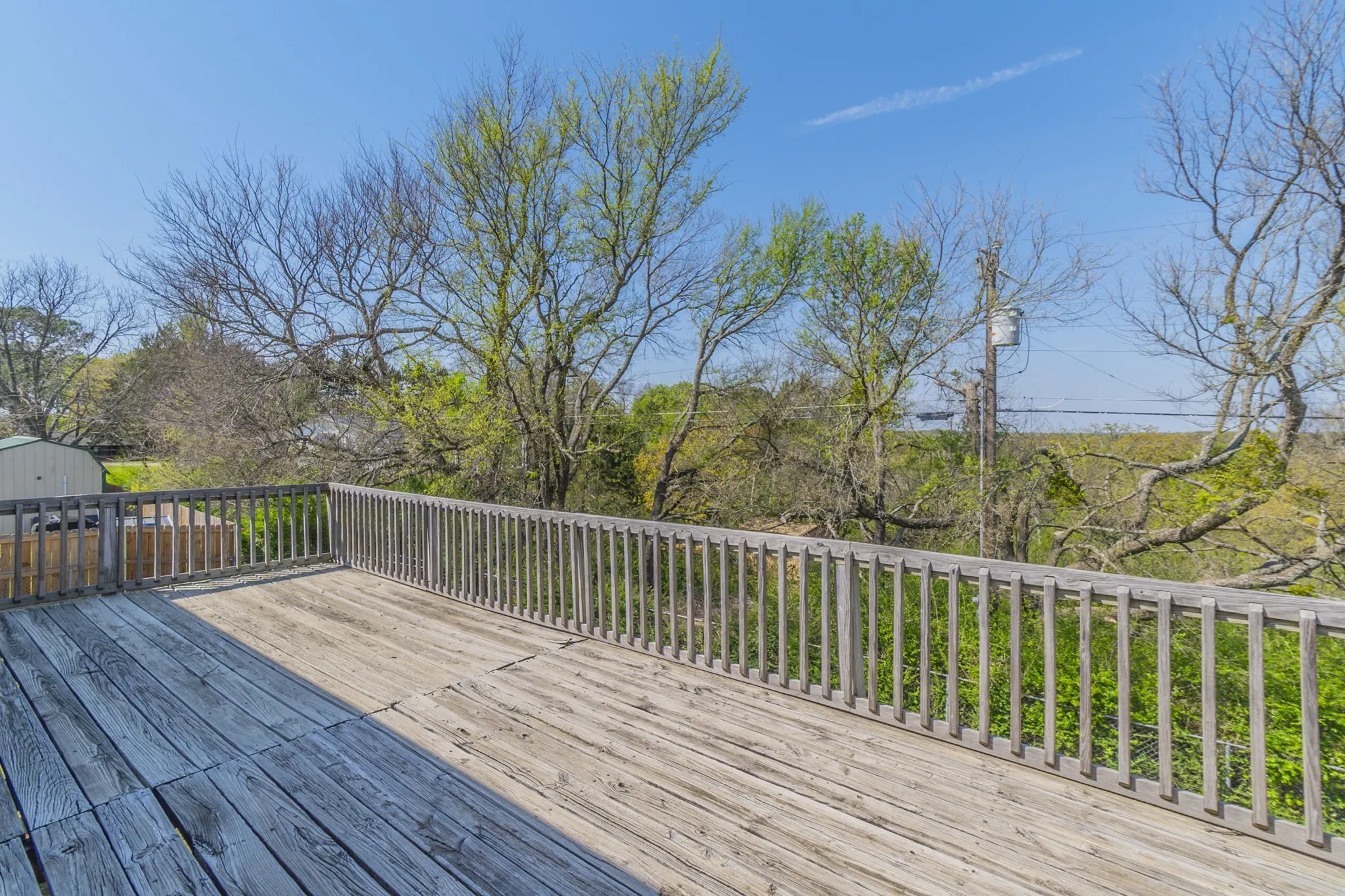 Ranging across the back of the second floor is this expansive deck, which you can reach from the primary bedroom or the kitchen.