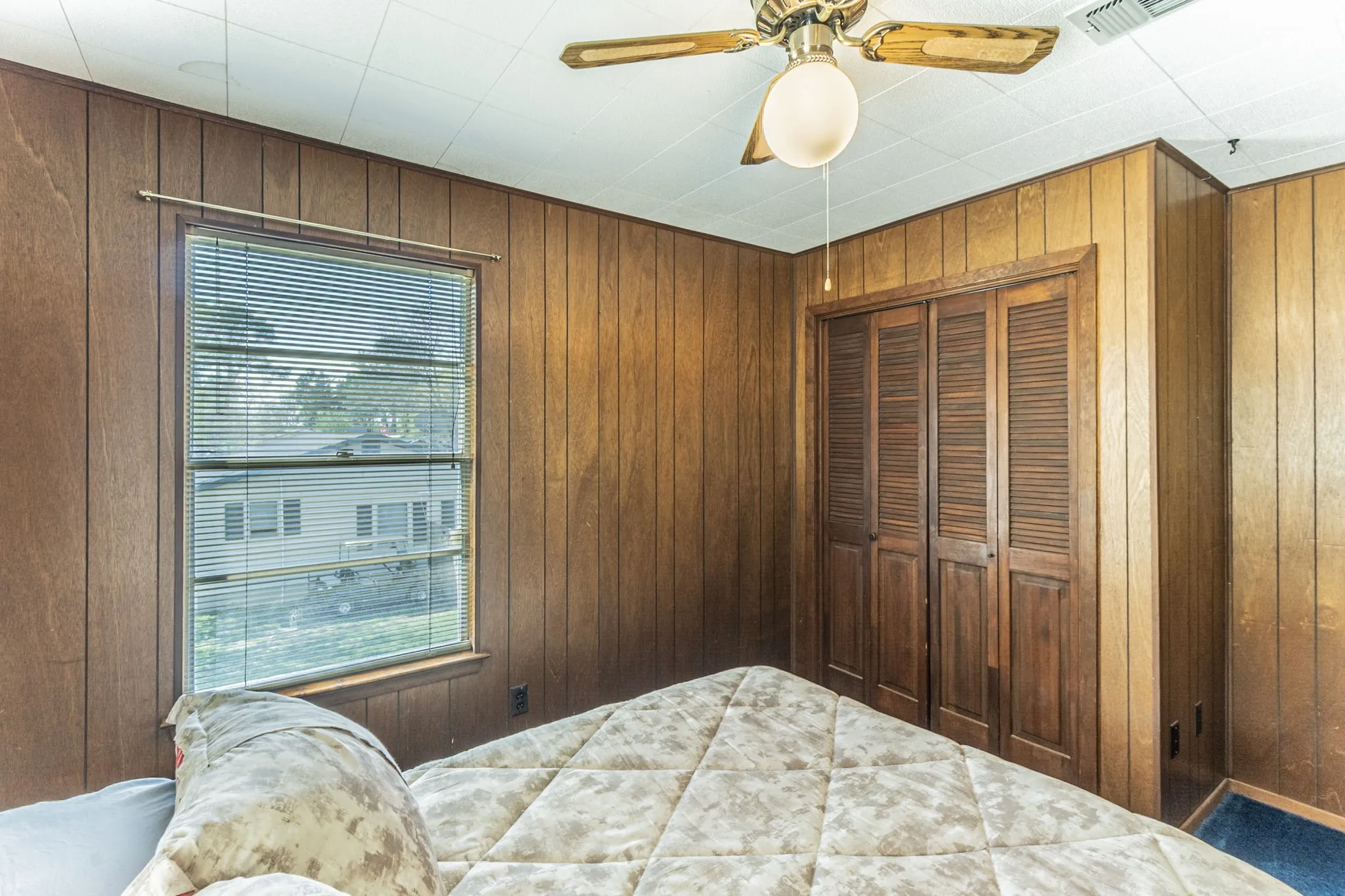 Bedroom #2 with closet and ceiling fan.