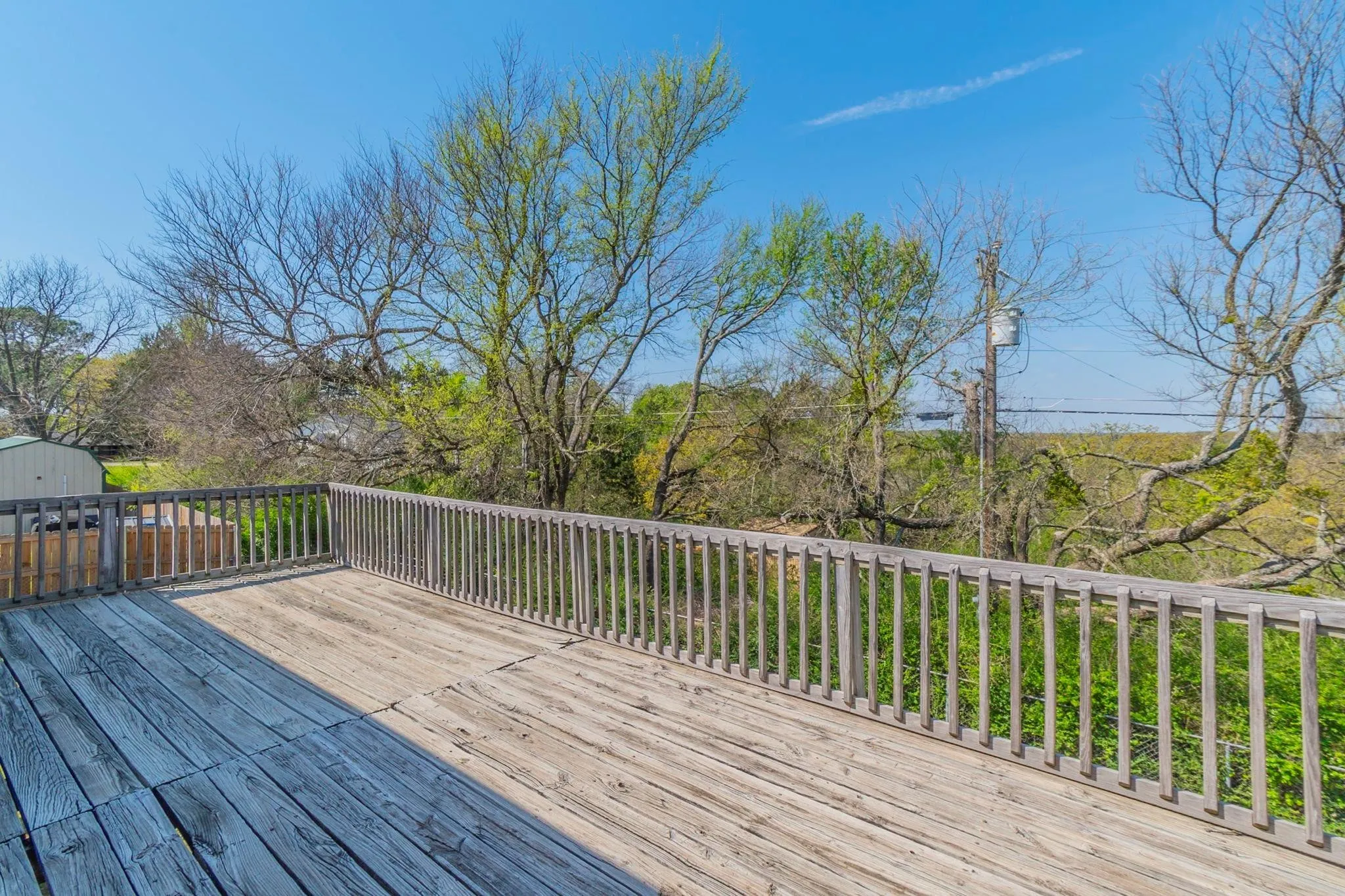 The wide deck spans the entire back of the second floor.