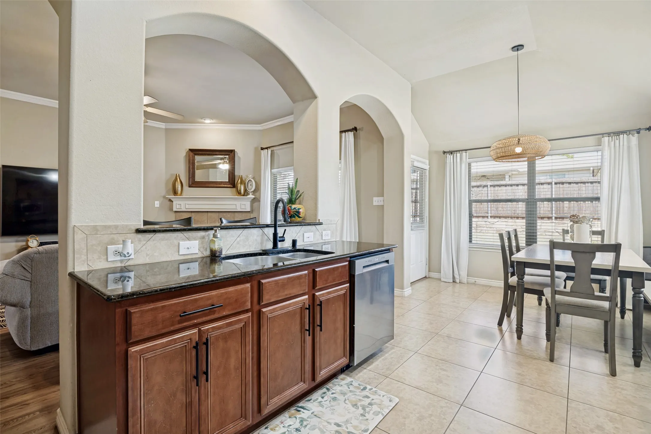 Arch openings provide access to living, kitchen and dining areas.