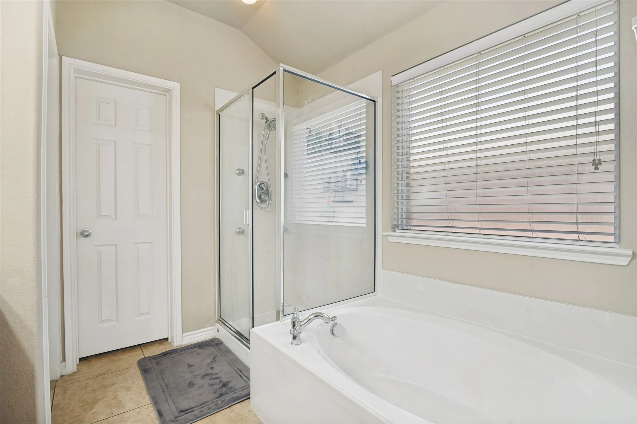 Separate stand up shower and tub in primary bathroom.
