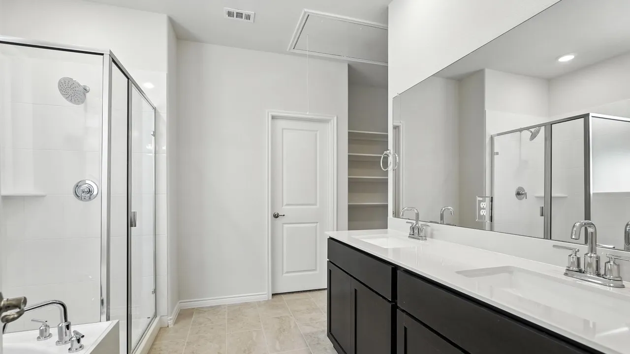Full bath featuring double vanity, a bath, a stall shower, and recessed lighting