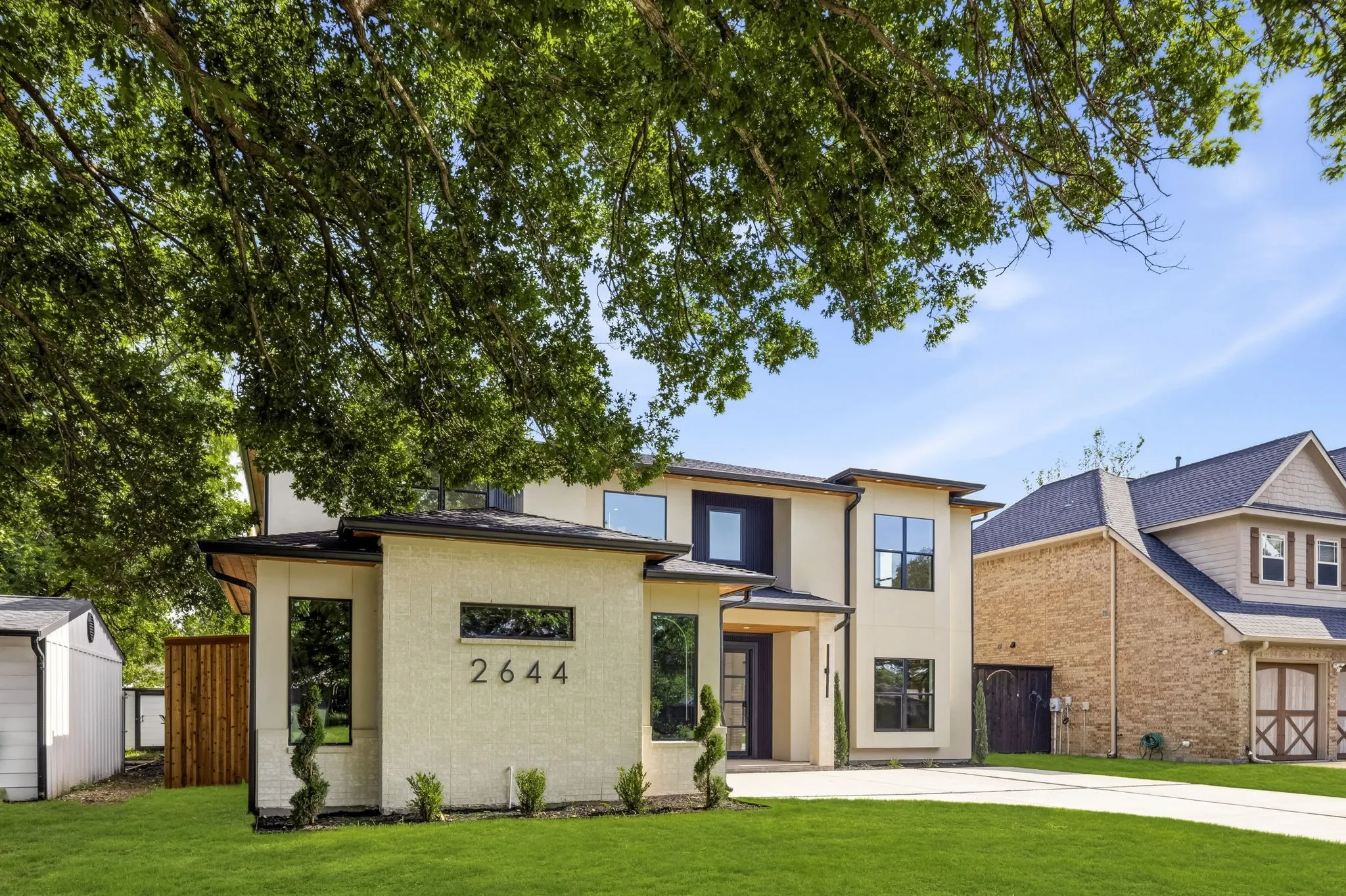 Modern exterior with a light stucco finish and contrasting dark trim