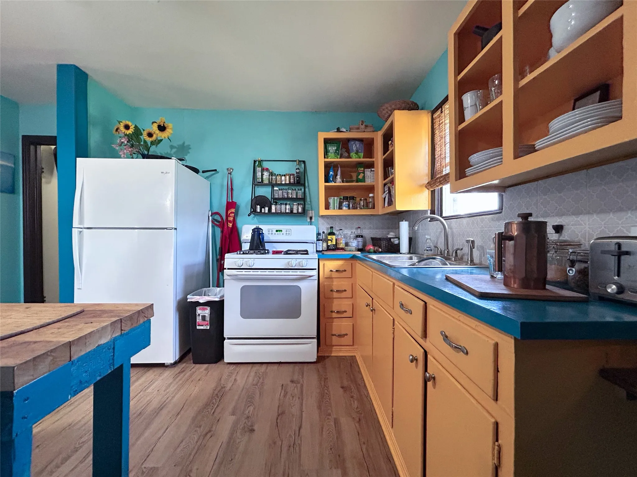 functional kitchen in trendy color scheme open to dining and window over the sink - 516 harlem, waco, tx 76704