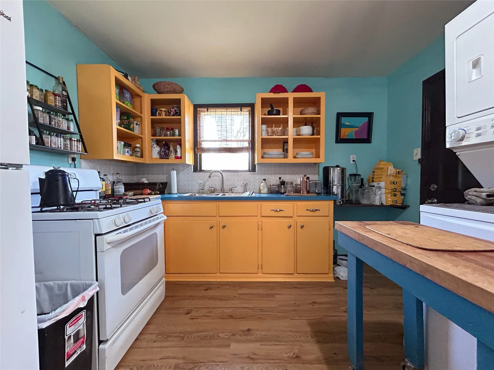 functional kitchen in trendy color scheme open to dining and window over the sink - 516 harlem, waco, tx 76704