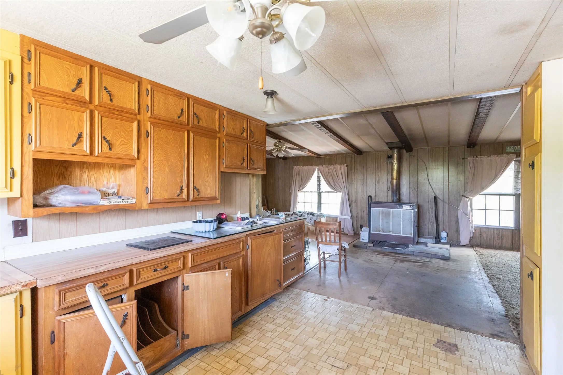 Kitchen space with wood cabinetry, light-toned countertops, and mosaic-patterned flooring