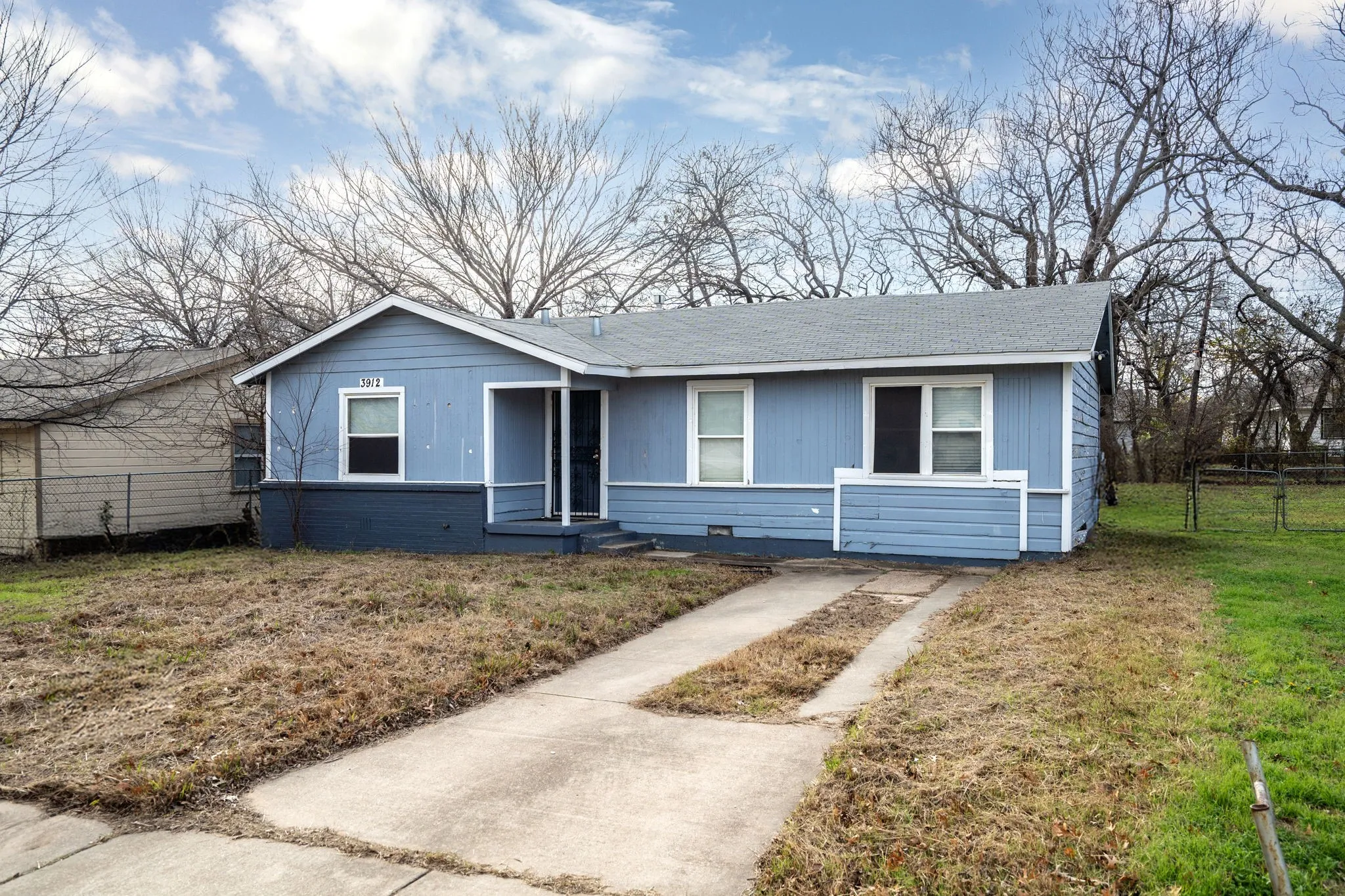 Single story home featuring a front lawn