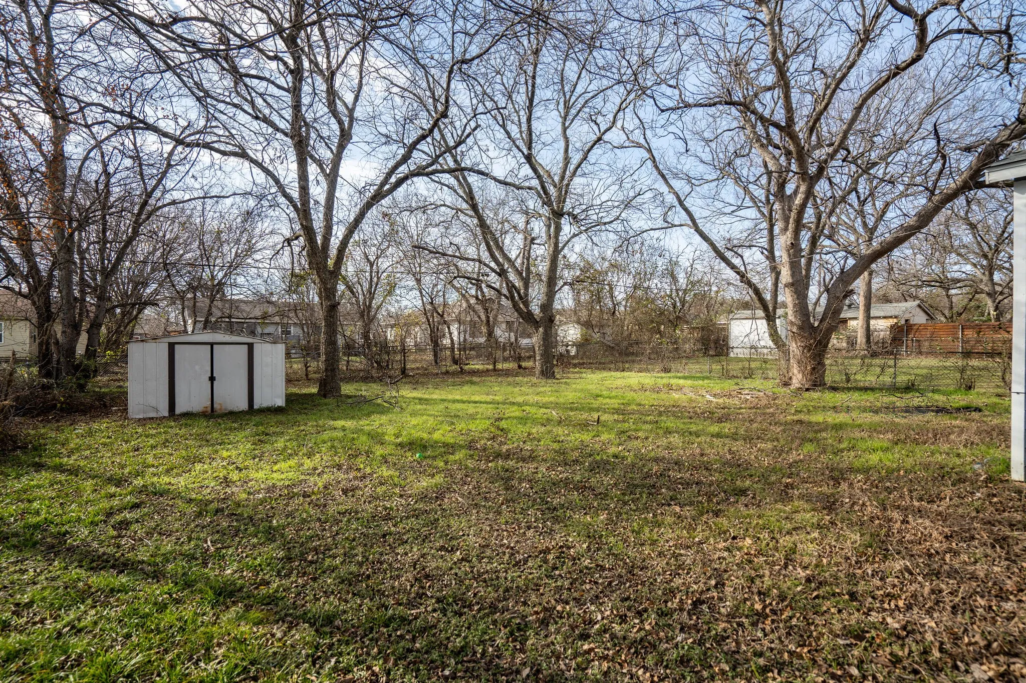 View of yard with a storage unit
