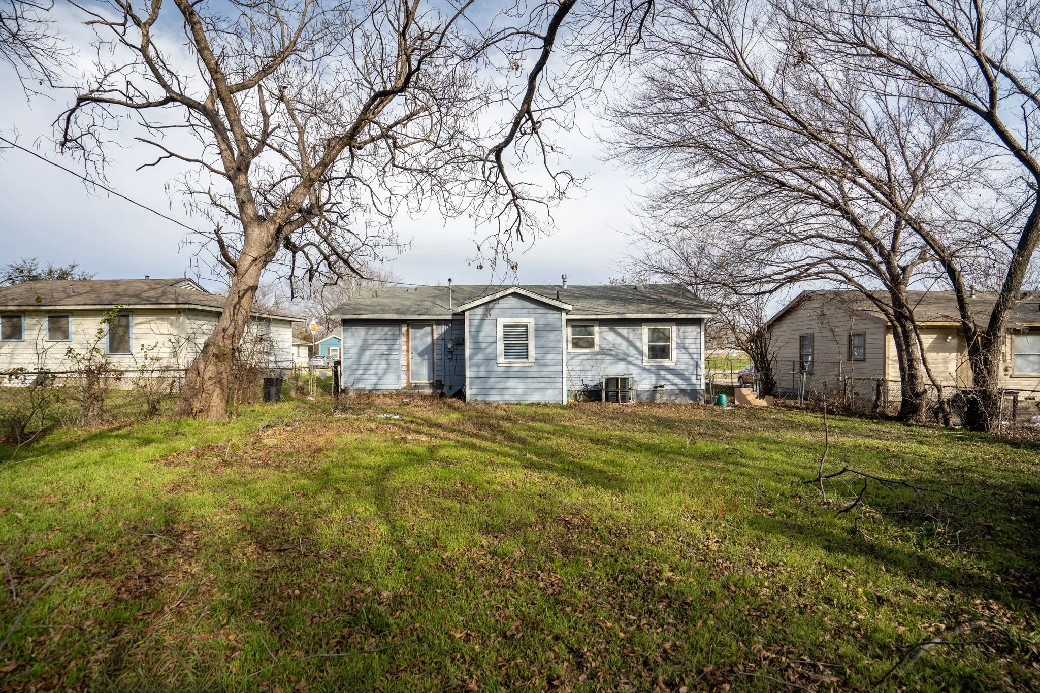 Rear view of house featuring a yard