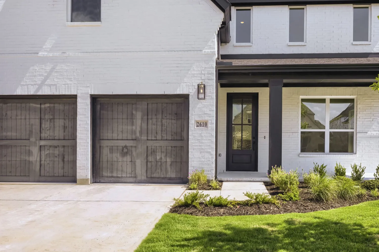 White brick exterior with a black trim roofline