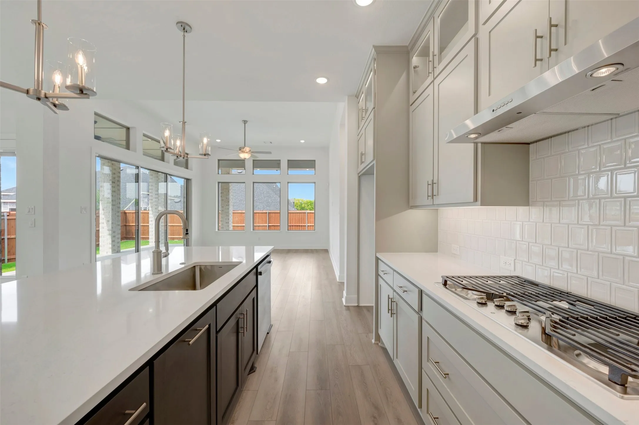 Gourmet kitchen with white countertops and white subway tile backsplash
