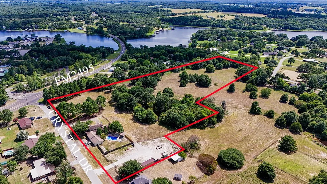 Aerial view of property's location with a nearby body of water and property boundaries highlighted
