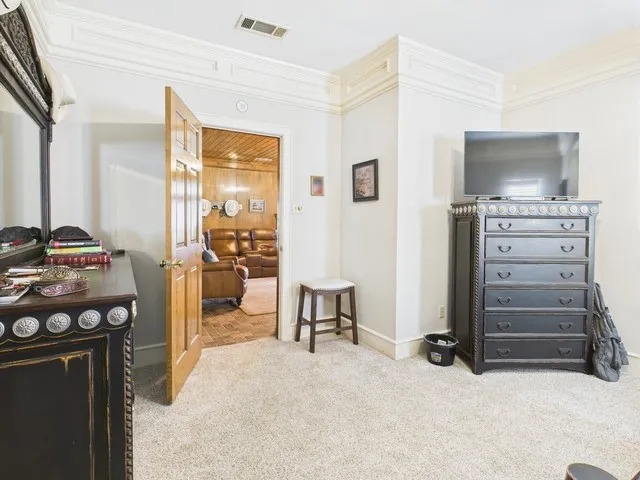 Bedroom with carpet flooring and crown molding