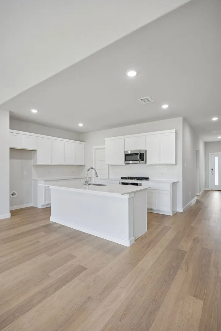 Kitchen in the Masters home plan by Trophy Signature Homes – REPRESENTATIVE PHOTO