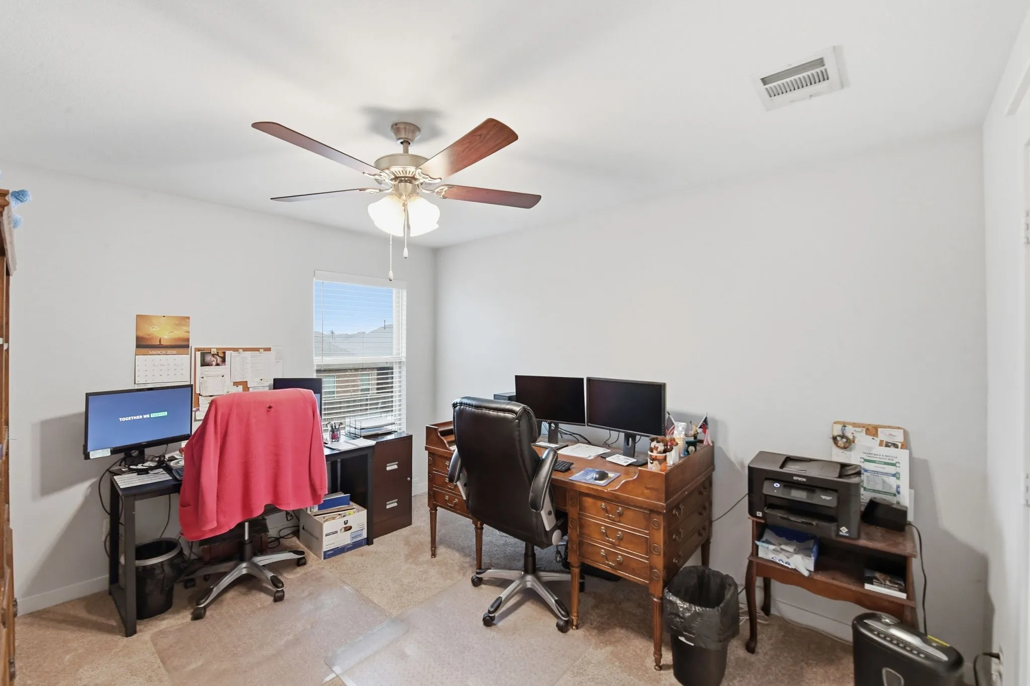 Office featuring light colored carpet and ceiling fan