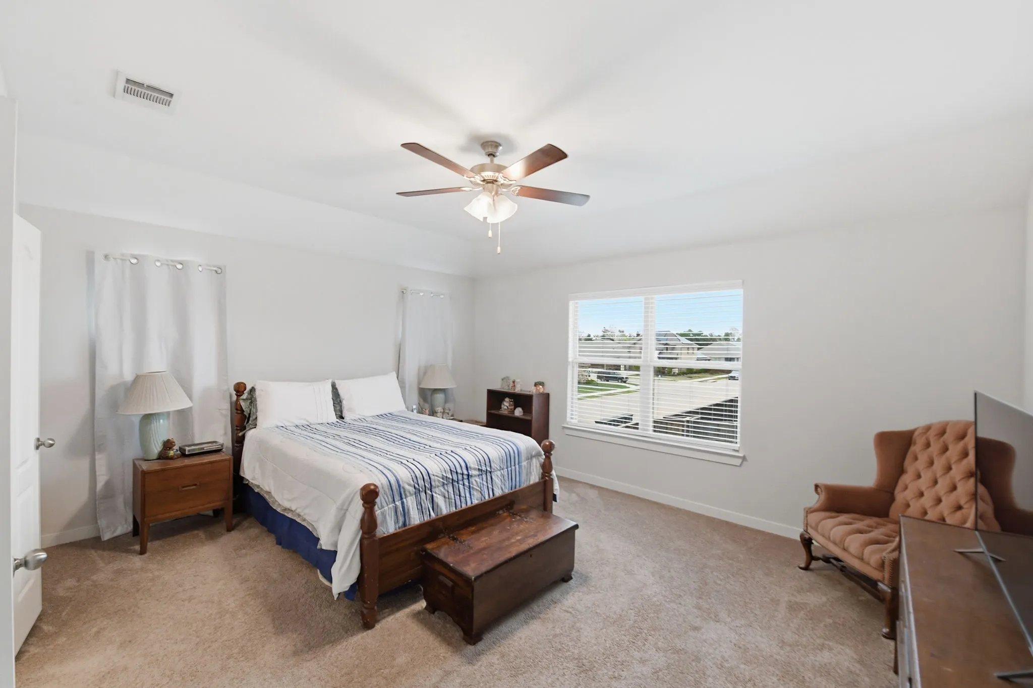 Bedroom featuring ceiling fan and light carpet