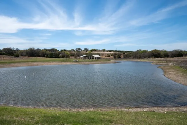Pond with view of Texas countryside and pavilions