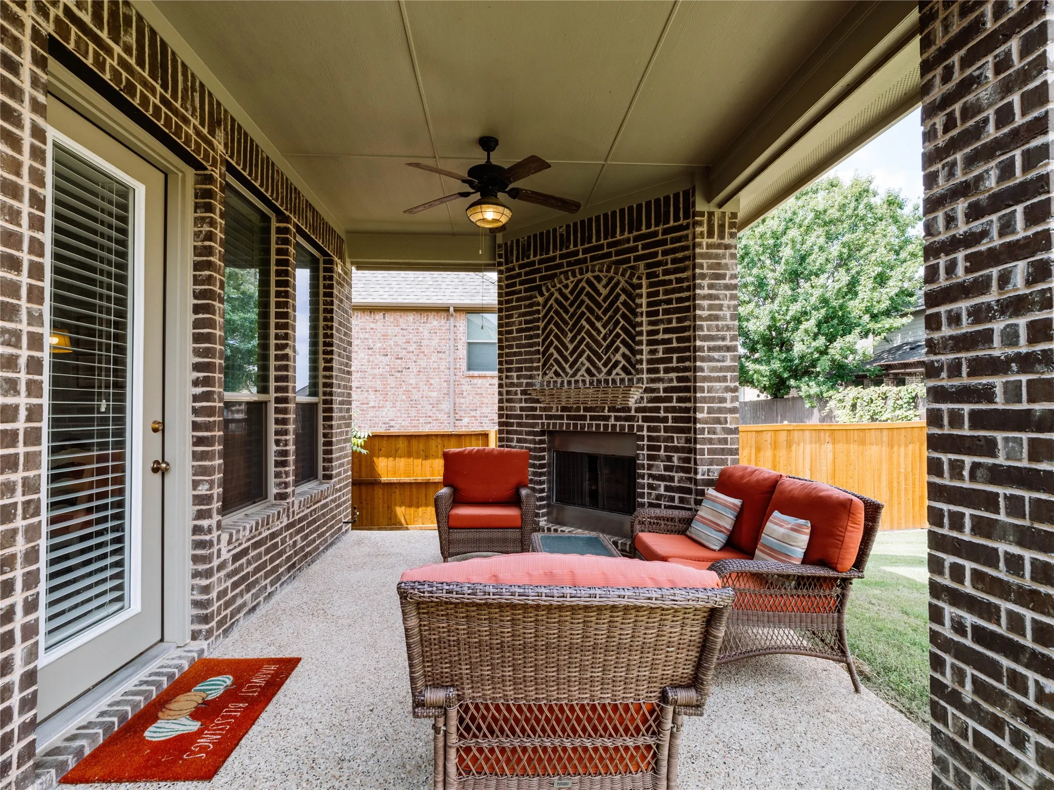 View of patio / terrace with a ceiling fan and an outdoor living space with a fireplace